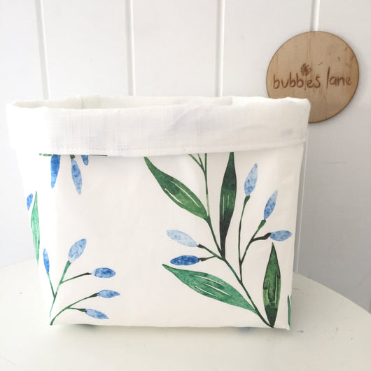 Blue branches with plain white linen fabric basket