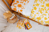 Yellow colour bomb with white linen cot quilt