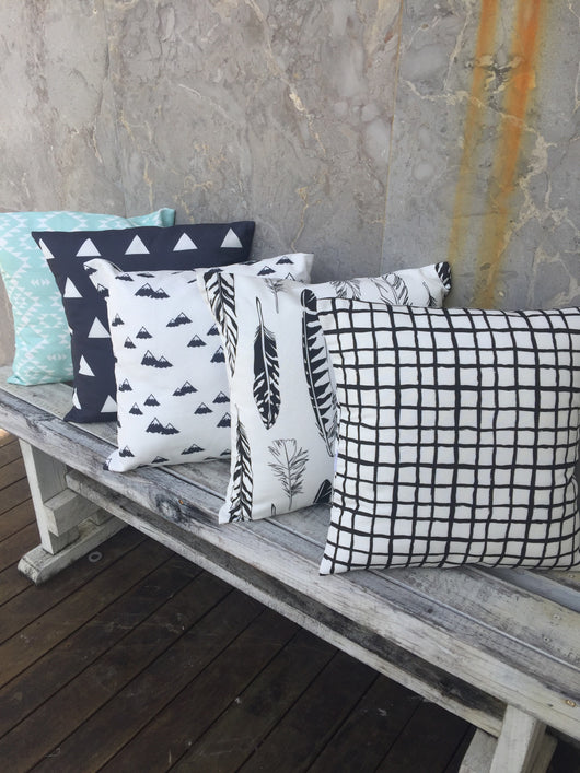 Mint Aztec, navy triangle, navy mountain, black feathers, black grid cushion cover